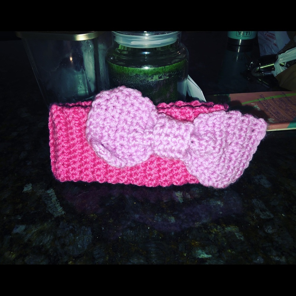 Handmade crochet pink ear warmer with purple bow